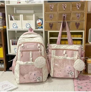 Lindo juego de mochila y bolso rosa con puntos, bolsillo de malla transparente y peluches adorables.