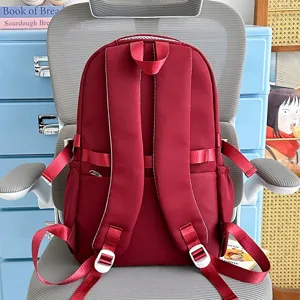 Dark red casual backpack back view, stylish daily school bookbag with comfortable shoulder straps.