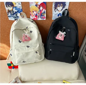 Canvas school backpack for students, cute cartoon embroidery, lightweight daily travel bag.