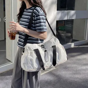 Large capacity travel duffel bag with adjustable shoulder strap for casual sports and gym use.