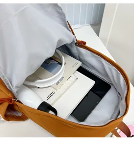 Detail view of the large capacity interior of the yellow student school backpack.