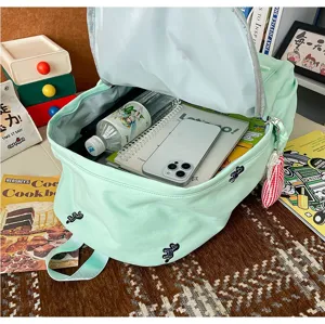 Detailed interior view of the cute light green school backpack showing spacious storage capacity.
