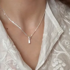 Delicate double layer silver clavicle chain featuring a minimalist teardrop pendant.