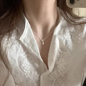 Exquisite teardrop double layer necklace, minimalist silver clavicle chain detail shot.