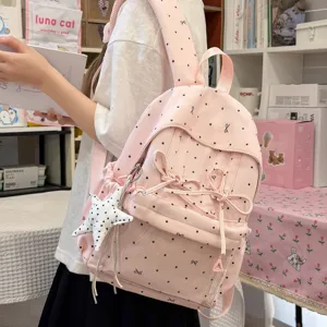 Pink polka dot sweet backpack with cute bow and star pendant for students and daily wear.