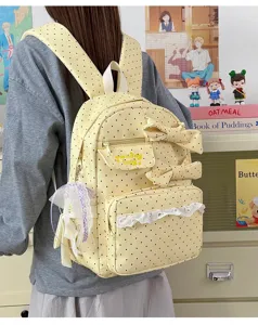 Yellow polka dot backpack detail showing cute bows, delicate lace trim and embroidery.