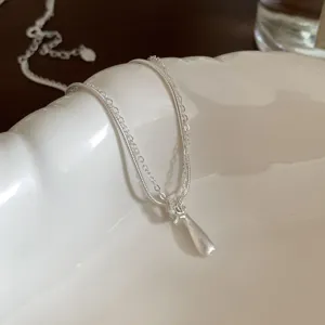 Exquisite double-layer necklace featuring a sleek droplet pendant and delicate chains.