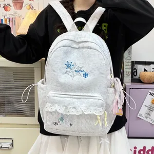 Light grey student backpack featuring delicate snowflake embroidery and sweet lace trim design.