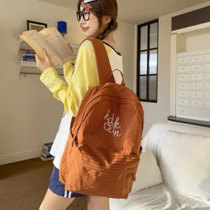 Stylish warm-toned plaid student backpack, lightweight casual daypack for school and daily use.