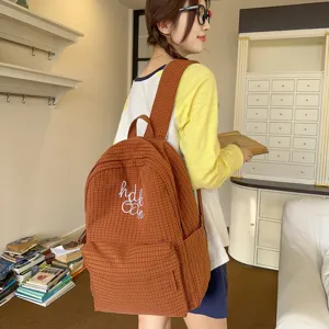 Brown checkered student backpack for women daily school lightweight cute bookbag close view.