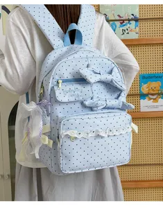 Sweet light blue polka dot backpack featuring cute bows and lace detail, perfect for daily use.