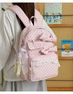 Pink polka dot backpack with cute bows and lace trim, sweet style for teen girls travel.