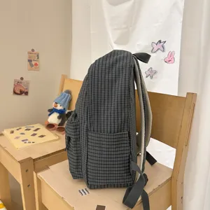 Dark grid student backpack detail view, lightweight casual daily school bag with front pocket.