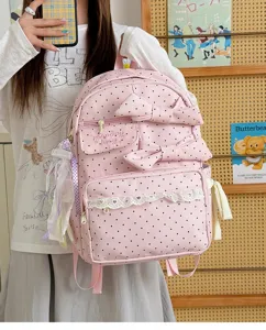 Cute pink polka dot backpack with sweet bows and delicate lace trim, perfect for school and travel.