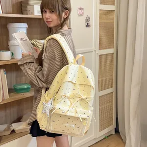 Cute yellow dot backpack with bow and star pendant, perfect for daily sweet school style.