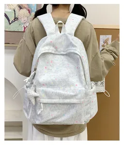 Detailed view of the cute grey star print backpack with star pendant, casual daily school bag.