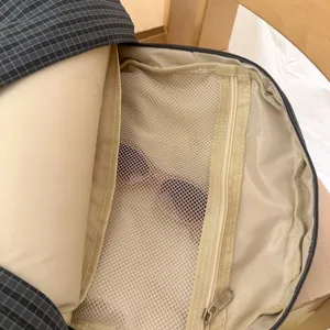 Backpack interior detail view showing mesh zipper pocket and storage design for daily commuting.