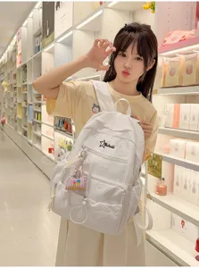 Ins style white school backpack for girls, large capacity casual rucksack with cute embossed design.