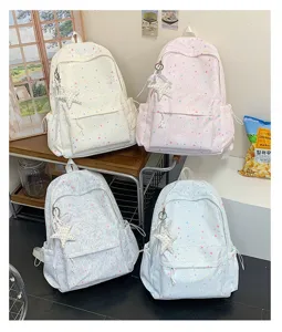 Detailed view of casual canvas backpacks with cute colorful star prints and star pendant.