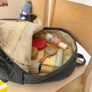 Detail view of the dark grid student backpack interior, showing spacious storage compartments.
