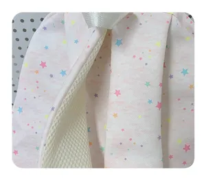 Close-up detail of pink star-printed fabric backpack featuring white drawstring and mesh lining.