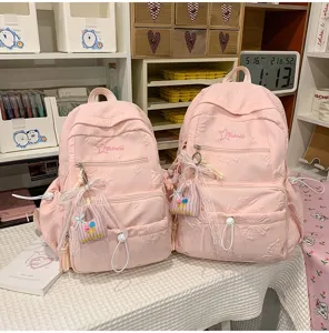 Pink casual backpack for girls, large capacity school bag with cute pendant and print design.