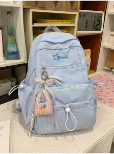 Stylish light blue school backpack for teen girls with embossed pattern cute pendants
