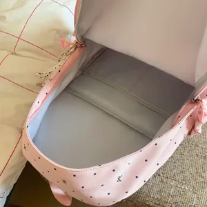 Pink backpack interior detail showing spacious compartments and soft lining fabric.