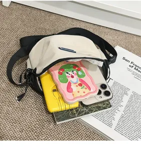 Detail view of casual outdoor crossbody phone bag showing interior capacity with items.