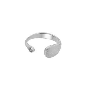 Silver adjustable open ring featuring textured water drop and sparkling zirconia stone.