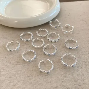 Exquisite silver open rings detail shot featuring blue crystal star accents for women forest style.