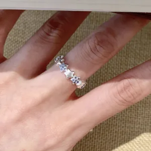 Close-up detail of silver star ring with blue gemstones, elegant minimalist finger jewelry.