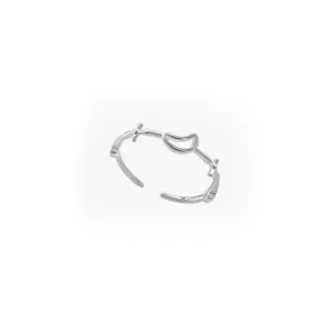 Close-up detail shot of silver open ring featuring crescent moon and cross design for women style.
