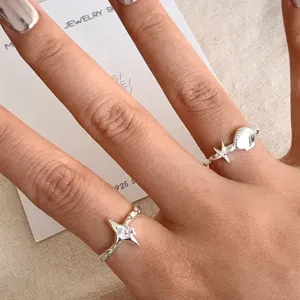 Silberne Stern und Muschel Offene Ringe Detailansicht mit filigranem Design und Zirkonia Stein.