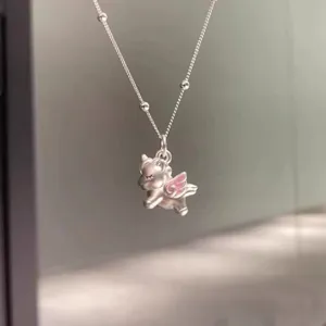 Detailed close-up view of the sterling silver unicorn pendant necklace with pink wing details.