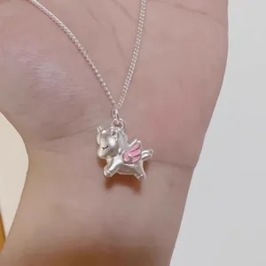 Silver unicorn pendant necklace detail view, cute pink wings design, stylish clavicle chain.