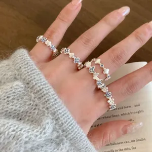 Exquisite silver stackable rings detail, featuring charming star, flower and butterfly motifs.
