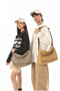Detailed shot of casual canvas messenger bag with wide strap, perfect for daily commute and outdoor.