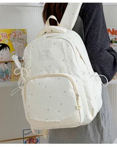 White sweet school backpack featuring all-over star print and delicate lace trim detail.