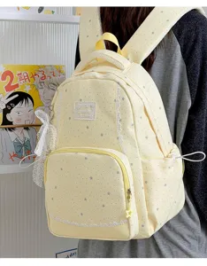 Detailed view of yellow star printed backpack with delicate lace trim and cute pearl bow.