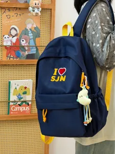 Navy blue student backpack with yellow straps and cute embroidery for daily school use.