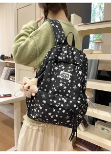 Black star pattern multi-compartment student backpack, casual commuter school day pack.