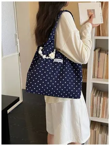 Chic navy blue polka dot canvas shoulder bag with pearl flower strap for daily casual wear.