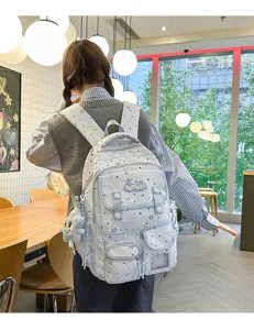 Detailed view of the light blue star pattern casual backpack with cute pendant and pockets.