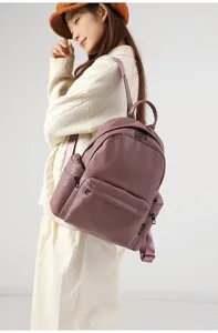 Detail view of stylish purple PU leather backpack worn by model, casual commuting design.