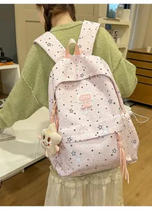 Pink star pattern backpack detail view, featuring cute plush star pendant and front pocket.