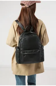 Black PU leather casual backpack detail showing texture, double straps and side pockets.