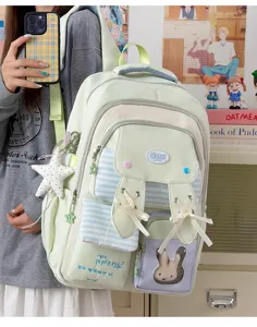 Cute rabbit ear school bag with ribbon decor, transparent pocket and fresh green tone for daily use.