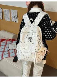 Detail view of the multi-compartment star pattern backpack, stylish street style student bag.