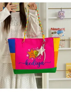 Detailed view of the colorful color-blocked canvas shoulder bag with braided straps and star graphic.